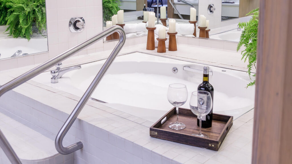 View of a bathtub with wine and two wine glasses