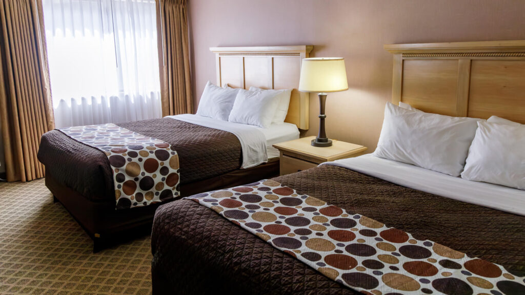 The inside view of a double queen room with two beds